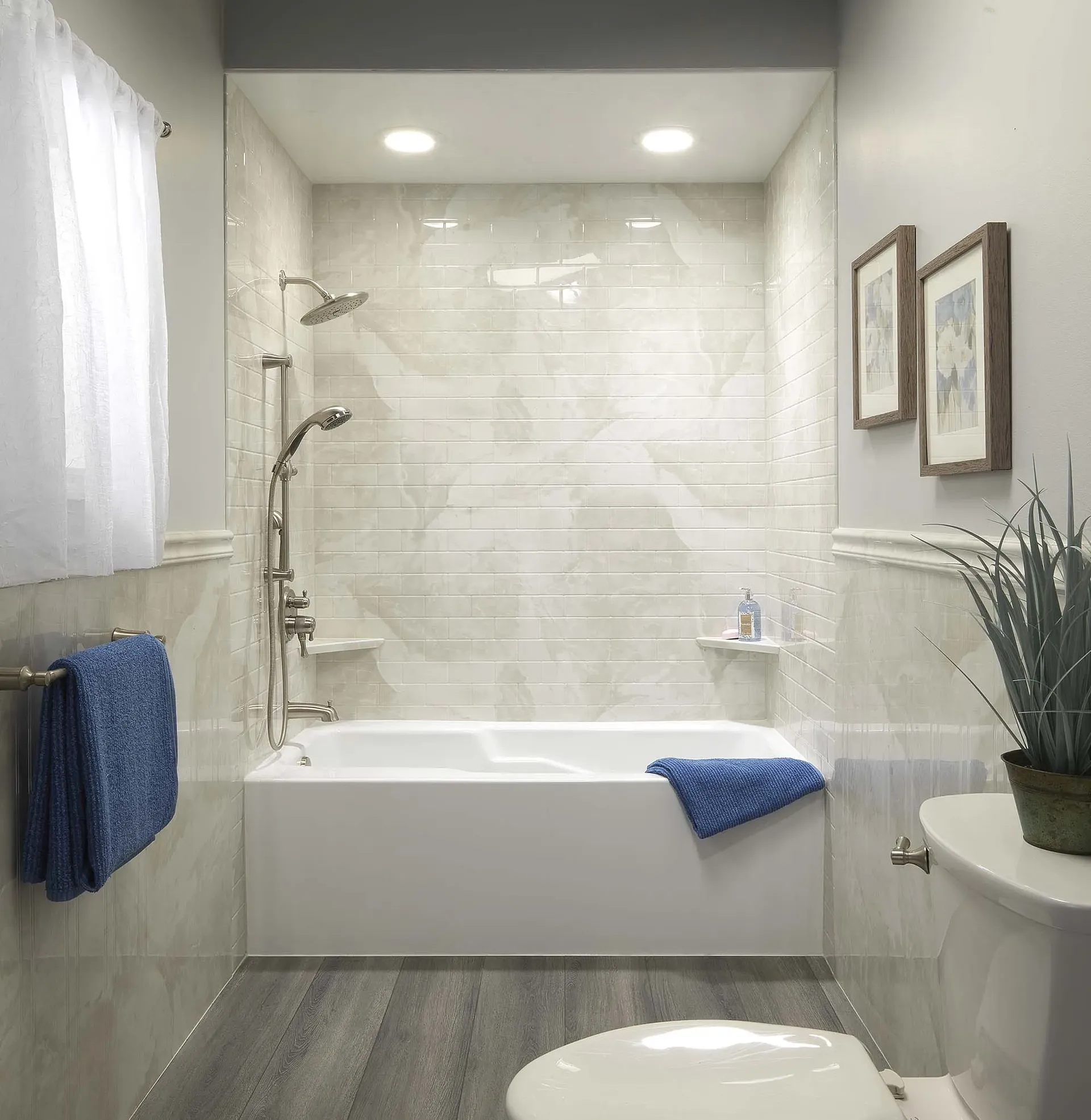 A white bathroom with off-white marbled tile walls and combination shower bathtub.